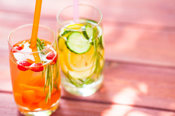 Fresh detox juices in glass bottles on the wooden background. Fruits and berries. Lifestyle, vegan food and drink, health care, diet and summer concept. Top view. Close up.
