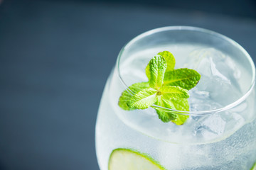 Martini royale cocktail in wine glass with lime and mint. Selective focus. Shallow depth of field.