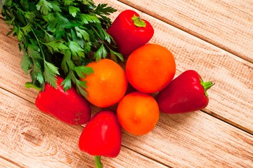 Fresh raw vegetables on the wooden background. Tomatoes and peppers. Vegan food, healthy food, diet and ingredients concept. Top view. Close up.