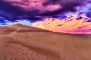 Fototapeta na wymiar Dunes Set pink stormy clouds
