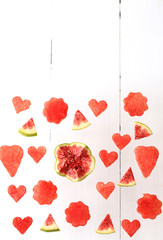creative background of watermelon and figs on a white wooden