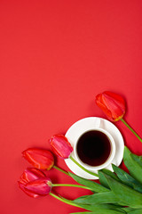 red flowers bunch is on red background with cup of coffee - love and holiday concept