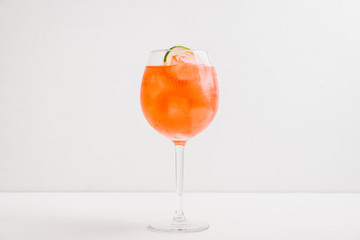 Rum based red cocktail with lime in wine glass. Selective focus. Shallow depth of field. 