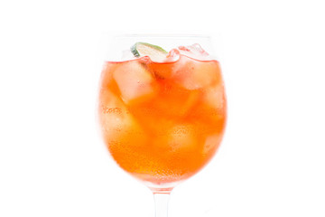 Rum based red cocktail with lime in wine glass isolated on white background. Selective focus. Shallow depth of field. 