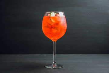 Rum based red cocktail with lime in wine glass. Selective focus. Shallow depth of field. 