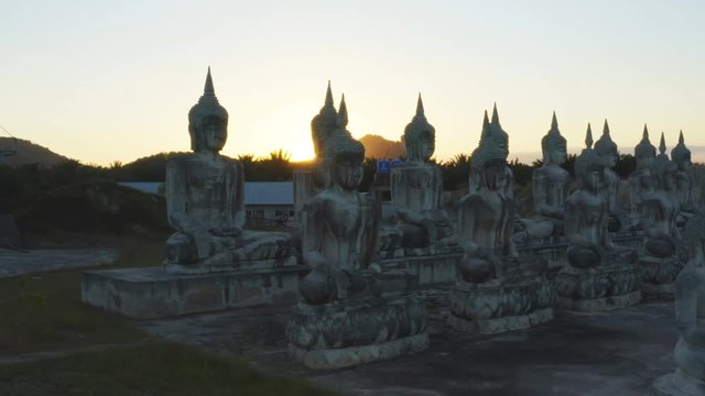 a lot of Buddha statues in sunset at the large field in Tungsong Nakornsrithammarat Thailand