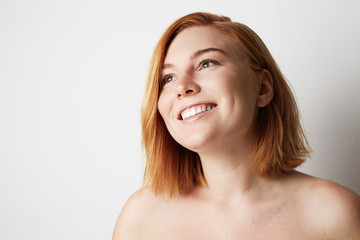 Happy young woman with natural make-up over white background. Close-up portrait