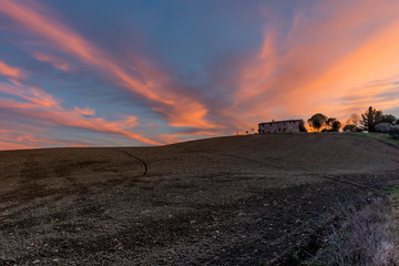 Ancient abandoned stone farmhouse at sunset, Sienese countryside, Tuscany, Italy