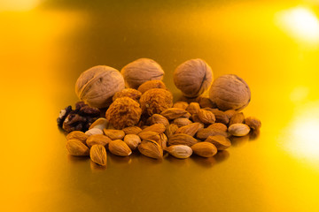 different nuts on a gold background