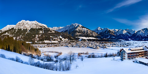 The valley Kleinwalsertal and Oberstdorf, Germany, with Alps in the winter with snow covered landscape in the afternoon.