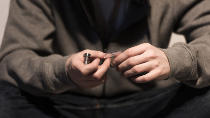selective focus of man holding smoking pipe and pack of marijuana