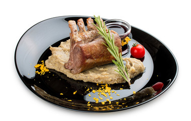 Rack of lamb with truffle puree on a black gloss plate