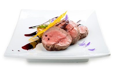 Veal medallions with wine sauce on white background