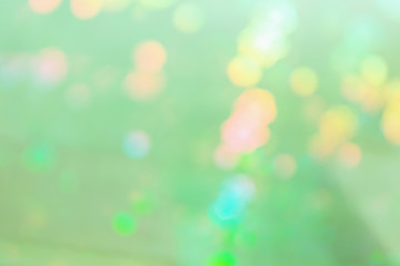 Light green abstract background with multicolored spots.