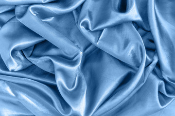 Abstract blue background. Smooth silk texture with beautiful folds.