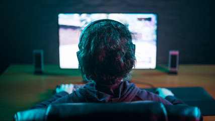 Men playing game on the computer with headphones © Digitalbarn