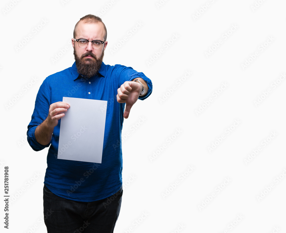 Sticker young hipster man wearing glasses and holding blank paper over isolated background with angry face, 