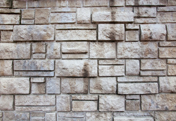 Closeup of old grey and rough sandstone wall. For pattern, texture and background