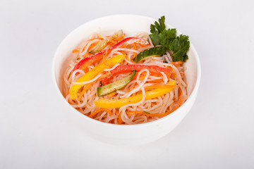 Chinese, fresh saladt from rice noodles of funchez with carrots, cherry tomatoes, sweet peppers and greens, for designer solutions in cooking