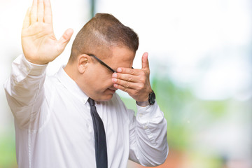 Middle age bussines arab man wearing glasses over isolated background covering eyes with hands and doing stop gesture with sad and fear expression. Embarrassed and negative concept.