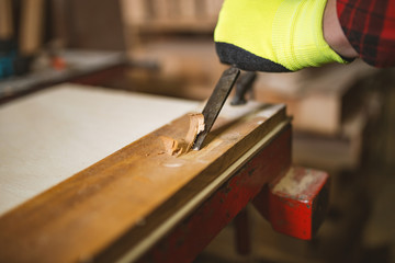 Carpenter working with gouge