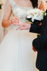 Young couple dresses her marriage wedding rings