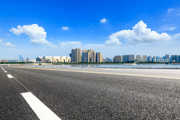Fototapeta premium Empty asphalt road and modern city skyline with buildings in Hangzhou