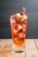 Sweet raspberry cocktail with lime slice. Selective focus. Shallow depth of field. 