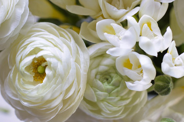 details of white  bouquet of freesia and buttercups