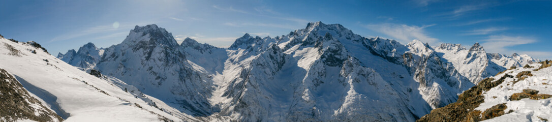 Fototapeta na wymiar Panoramic view of snow covered Caucasus mountains, Dombai, Karachai-Cherkess, Russia.
