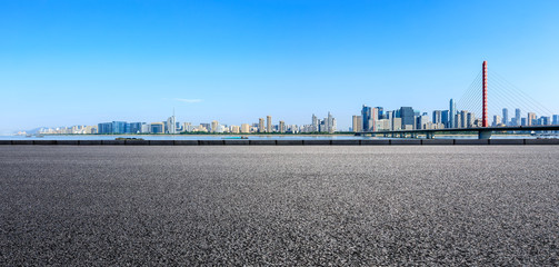 Fototapeta na wymiar Empty asphalt road and modern city skyline with buildings in Hangzhou