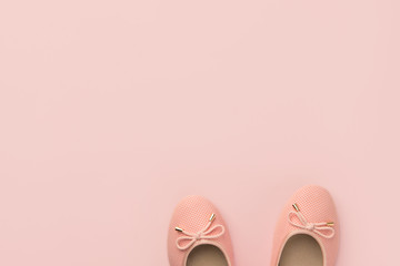 Pair of women's girl's ballerina pink pumps flats on same color background. Minimalist flat lay design template for product branding composition collages. Stylish poster banner with copy space