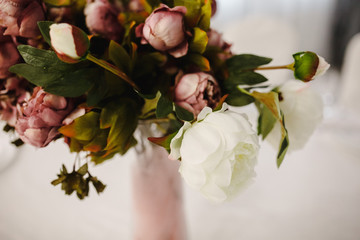 Flower bouquet of artificial peony flowers on a table. © CRISTINA
