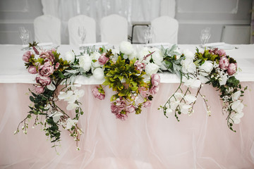 Flower bouquet of artificial peony flowers decorated on a table.