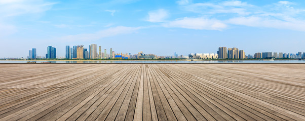 Empty wooden plank platform and Hangzhou city skyline
