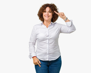 Beautiful middle ager senior businees woman over isolated background Smiling pointing to head with one finger, great idea or thought, good memory