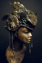 Bronze head of mannequin in decorated bronze fantasy hat