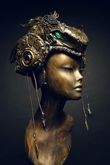 Bronze head of mannequin in decorated bronze fantasy hat