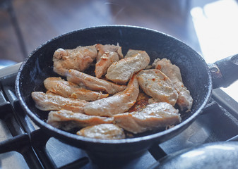 fried chicken fillet in a frying pan