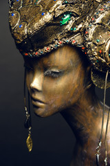 Bronze head of mannequin in decorated bronze fantasy hat