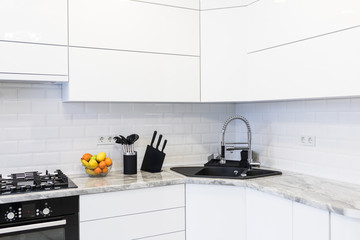 Modern interior decoration of a bright kitchen with sink accesories and fruits