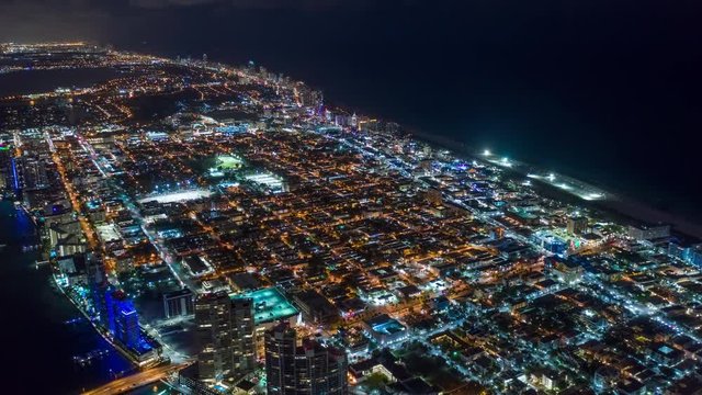 MIAMI, FLORIDA, USA - JANUARY 2019: Aerial drone panorama view flight over Miami beach at night. Aero dronelapse in 4K.