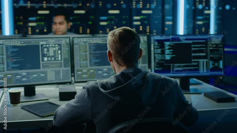 Fototapete IT Specialist Works on Personal Computer with Screens Showing Software Program with Coding Language Interface. In the Background Technical Room of Data Center with Professional Working