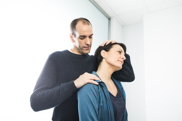 Physiotherapist stretching a patient neck. Physiotherapy and rehabilitation