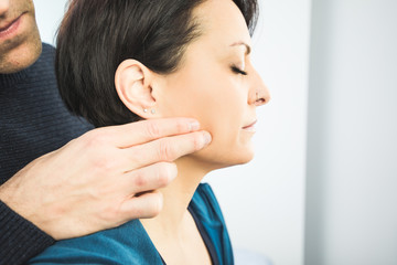 Physiotherapist massaging a patient face. Facial physiotherapy