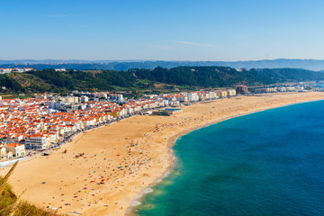 Fototapeta na wymiar From the high point of the Nazare we can see the beach the sea and the village Nazare, Portugal