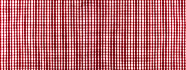 Red and white checkered classic tablecloth fabric closeup, clean background.