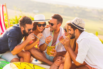 Friends drinking pineapple cocktail