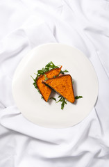 Meat sandwich with cheese and greens on a white background