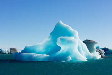 Bizarre shapes of melting blue ice calved off Vatnajokull glacier floating in Jokulsarlon glacier lagoon, Iceland, IS, Europe